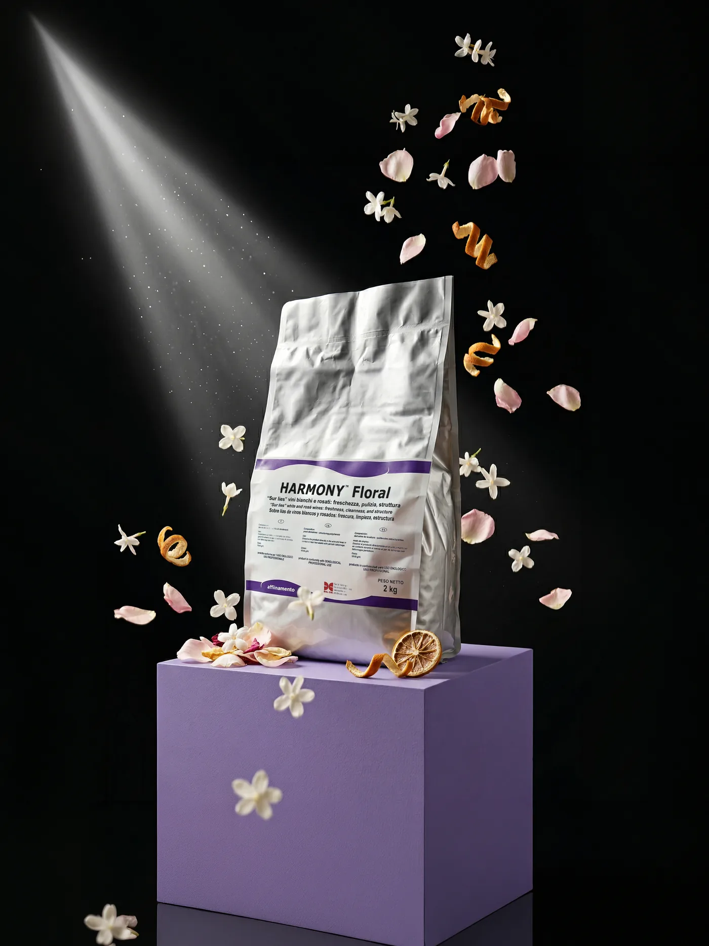 Confezione di Harmony Floral su un piedistallo lilla, tra petali e fiori in volo